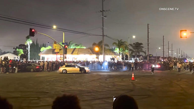Street takeover crowd climbs on, tags Metro bus in Los Angeles