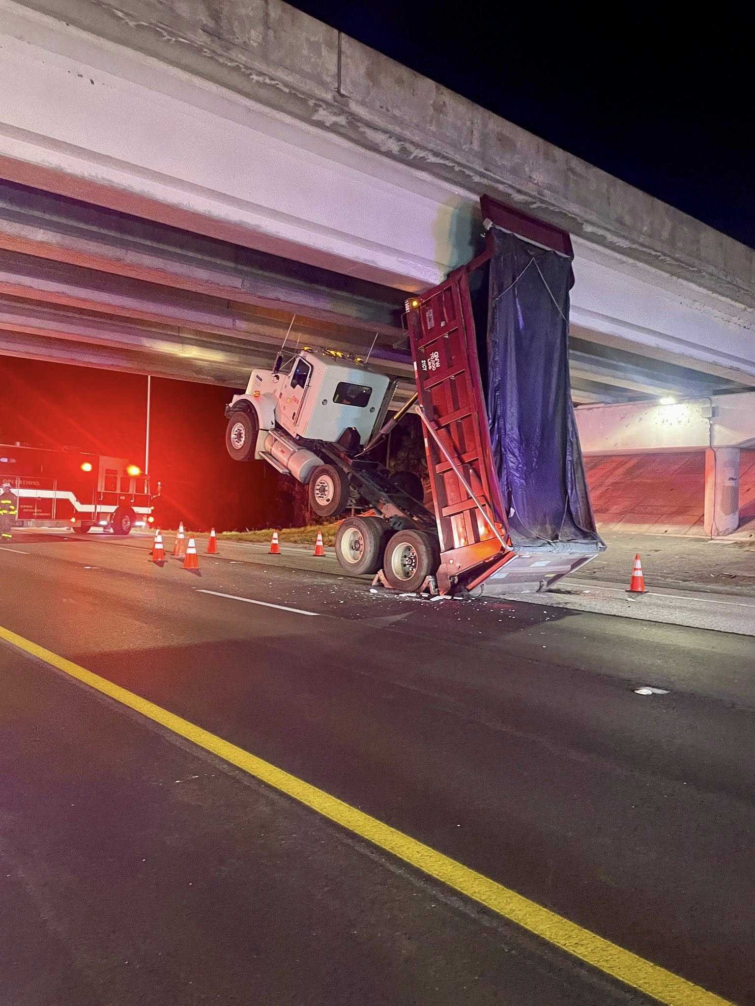 Dump truck strikes overpass bridge on I-95 in Martin County