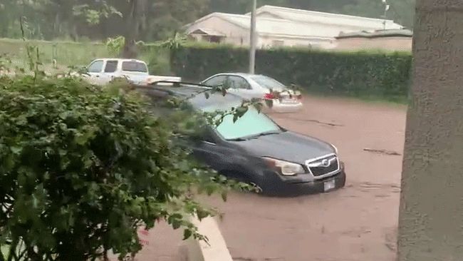 Cars partially submerged as heavy rain brings flash flooding