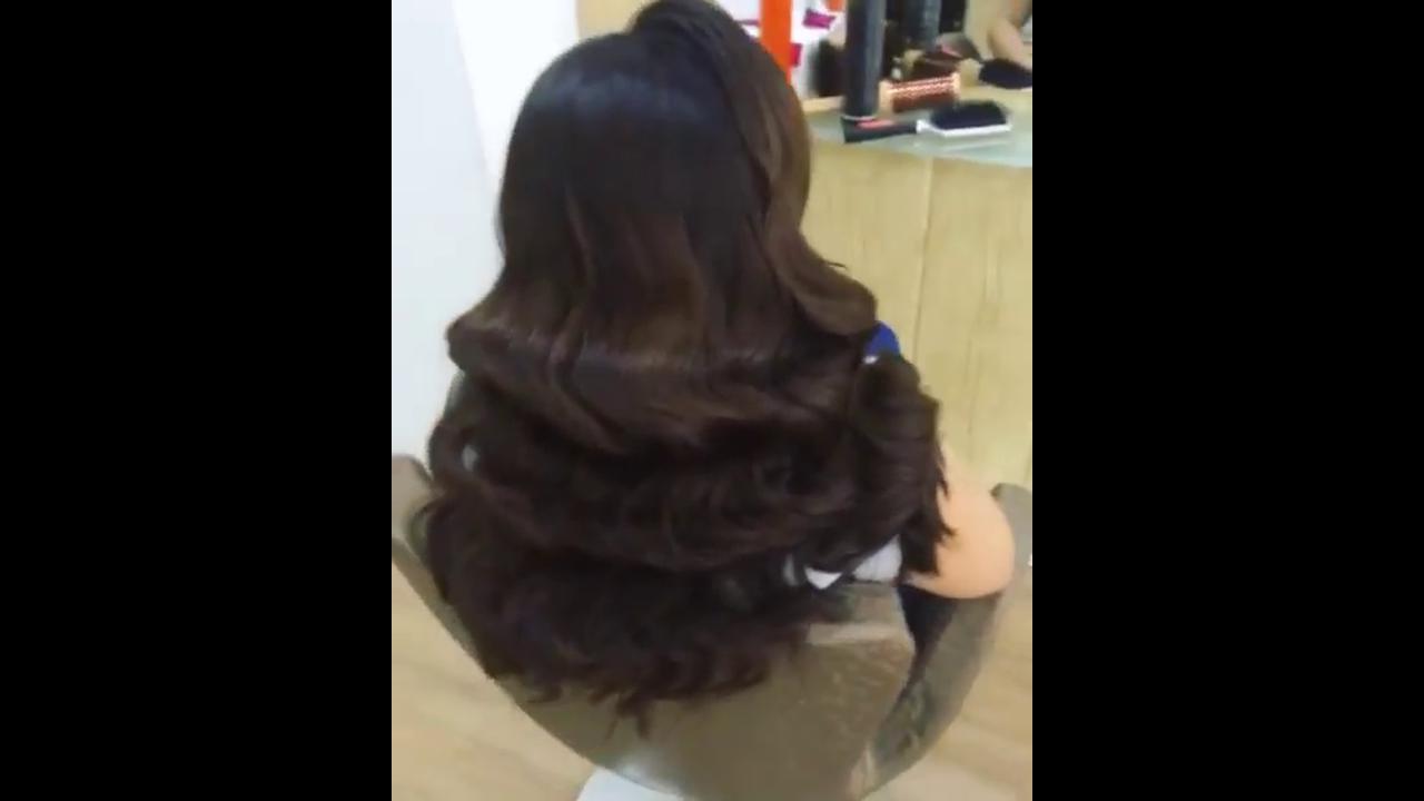 Styling rich dark brown hair with bouncy glam layered waves