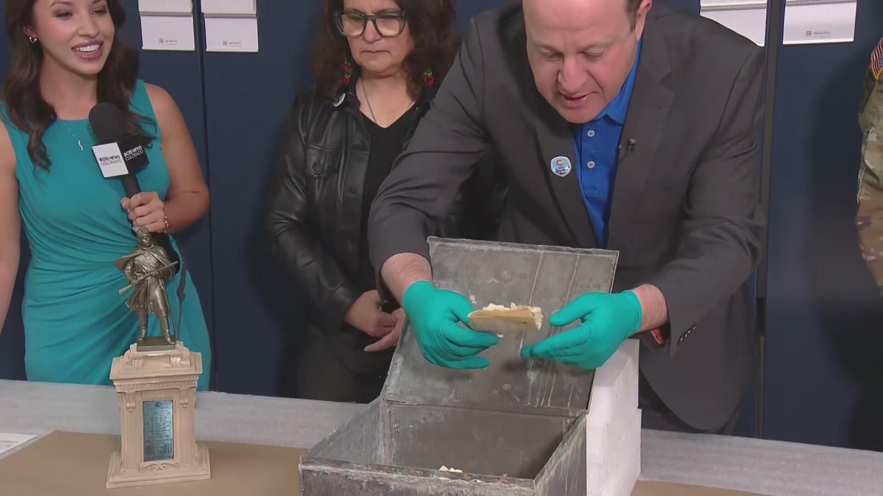 Gov. Jared Polis opens box from 1907 found underneath statue at ...