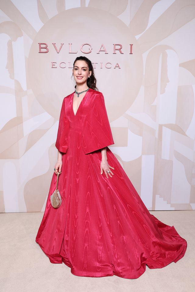 Anne Hathaway pairs sleeveless sheer gown made of mesh ribbons with over  $100,000 of diamond and emerald jewelry