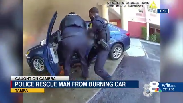 Tampa police rescue man from burning car