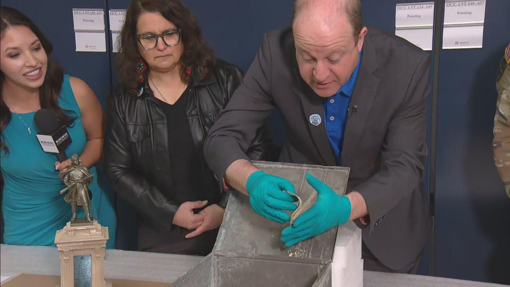 Colorado Gov. Jared Polis opens 1907 time capsule found underneath ...
