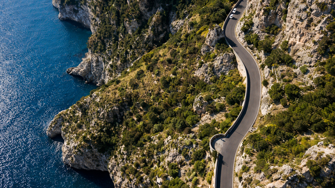 Driving along a stunning coastal road between cliffs and ocean