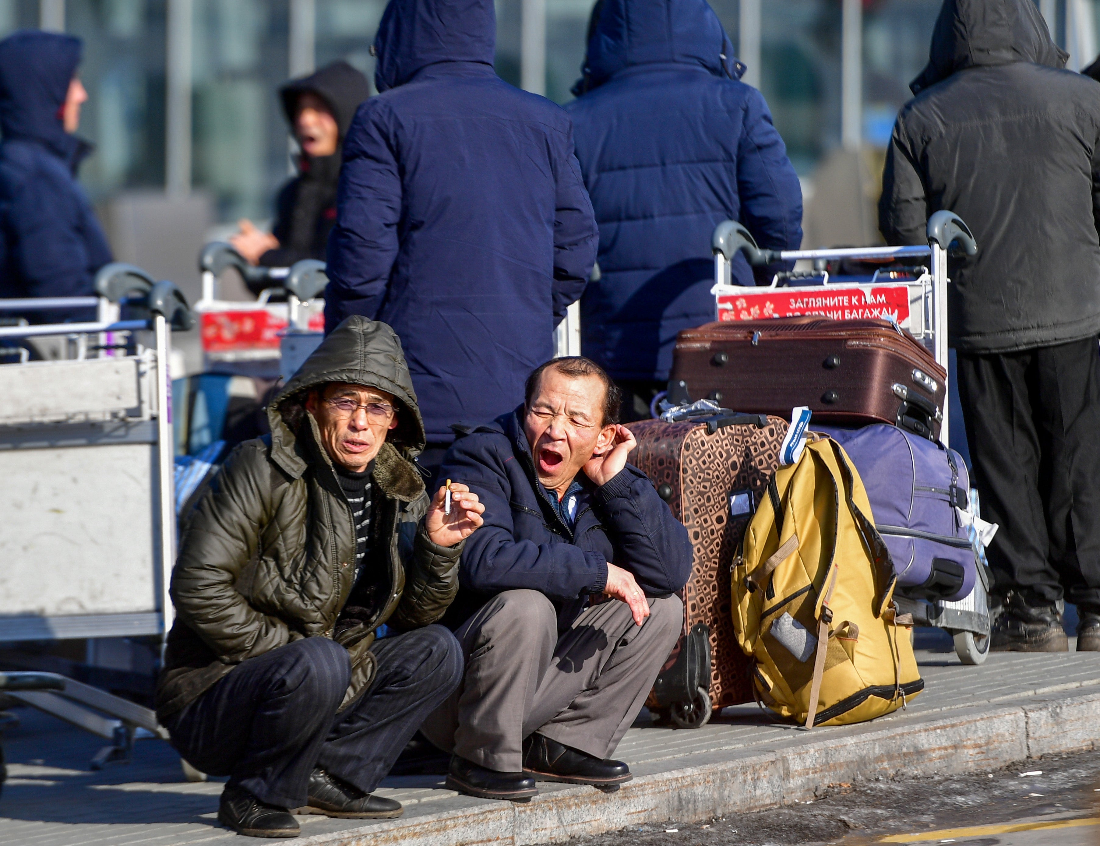 File: North Korean workers wait for their flight at the airport of Vladivostok (AFP via Getty Images)