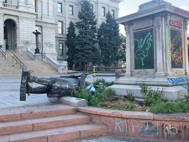 Colorado Gov. Jared Polis opens 1907 time capsule found underneath ...
