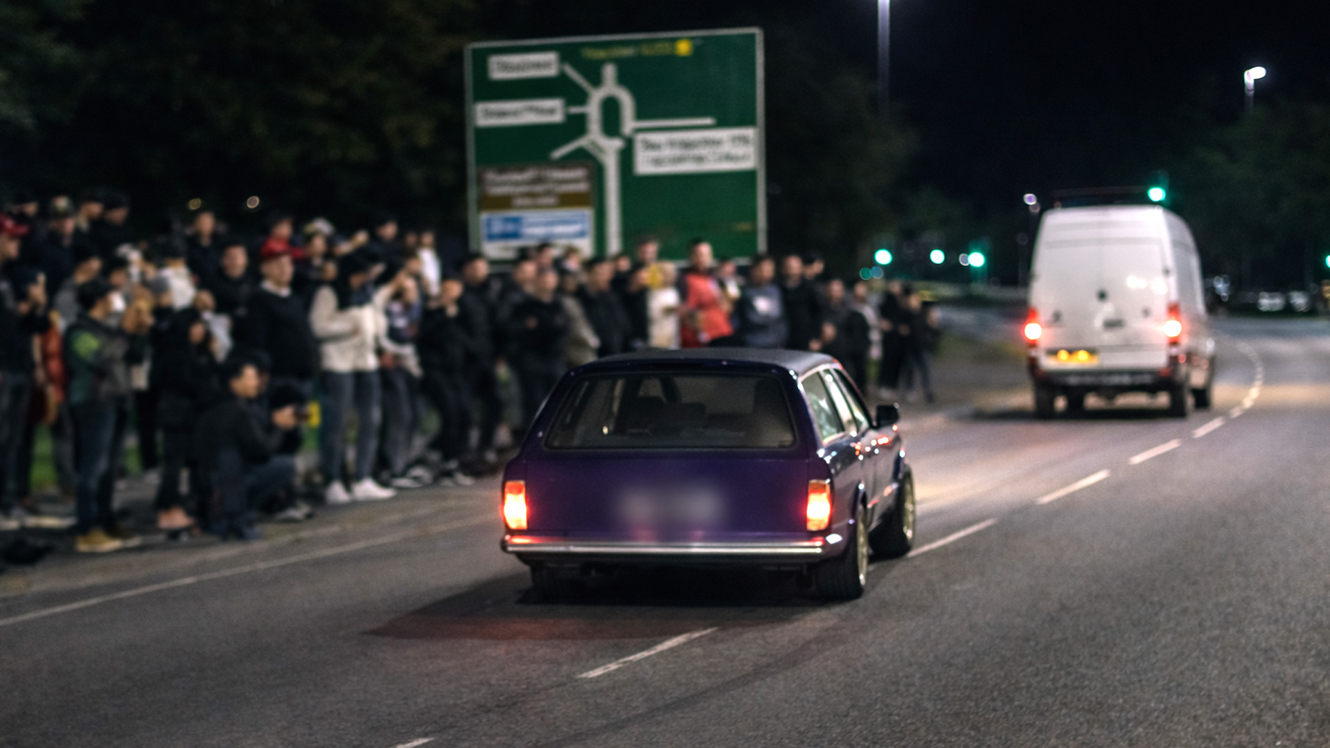Modified cars nearly crash while leaving car meet