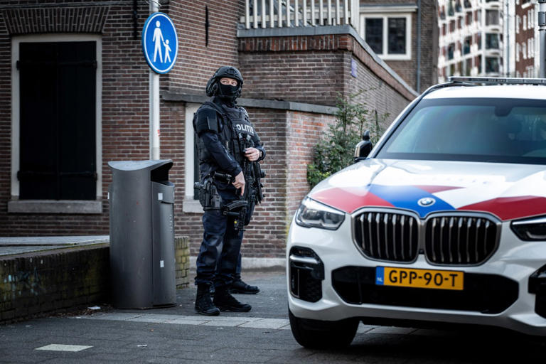 A police officer standing guard in front of the Jewish Museum in Amsterdam.