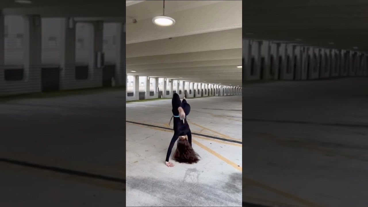 Watch model perform impressive cartwheels in an empty parking lot