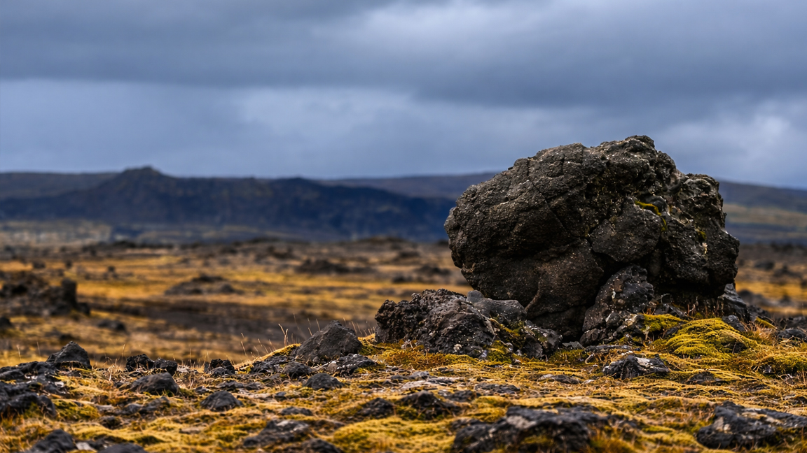Dramatic volcanic terrain covered with moss and scattered rocks