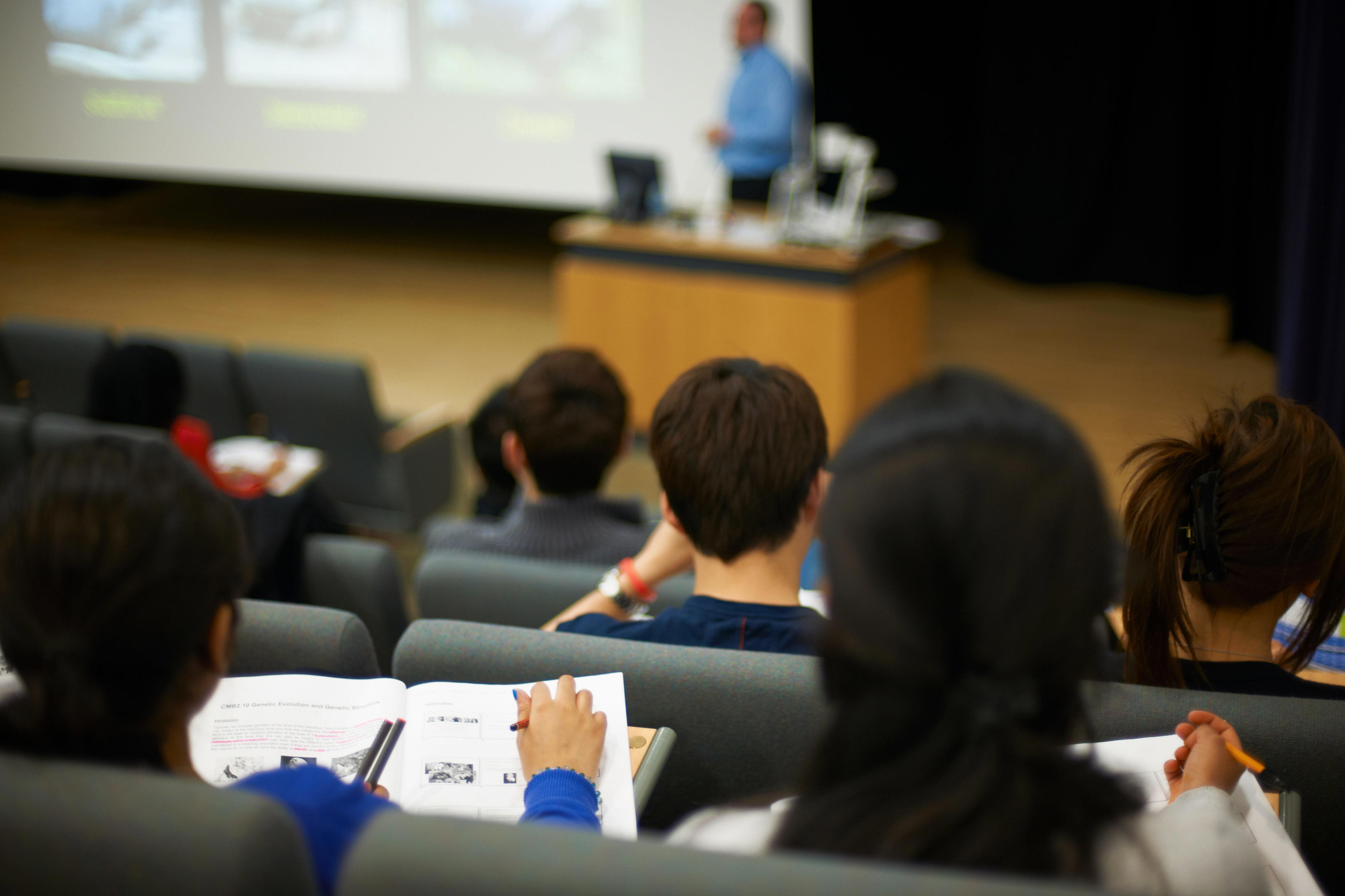College classroom with a professor in foreground