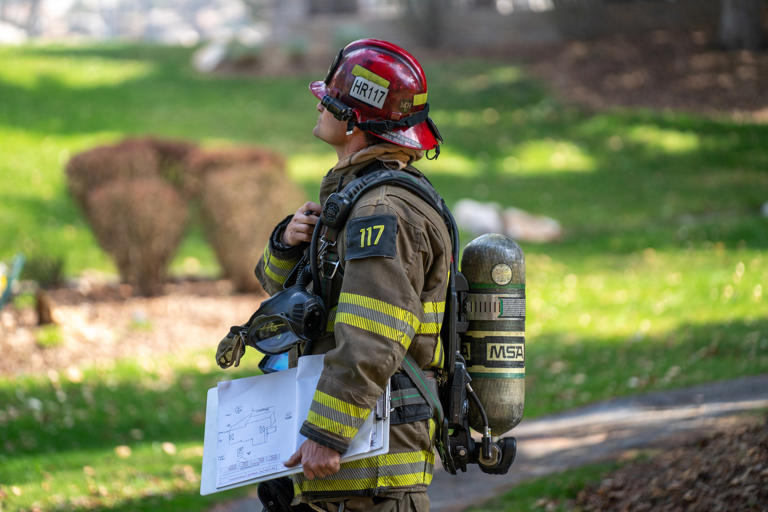 Firefighters battle house fire in Sandy, smoke and flames visible