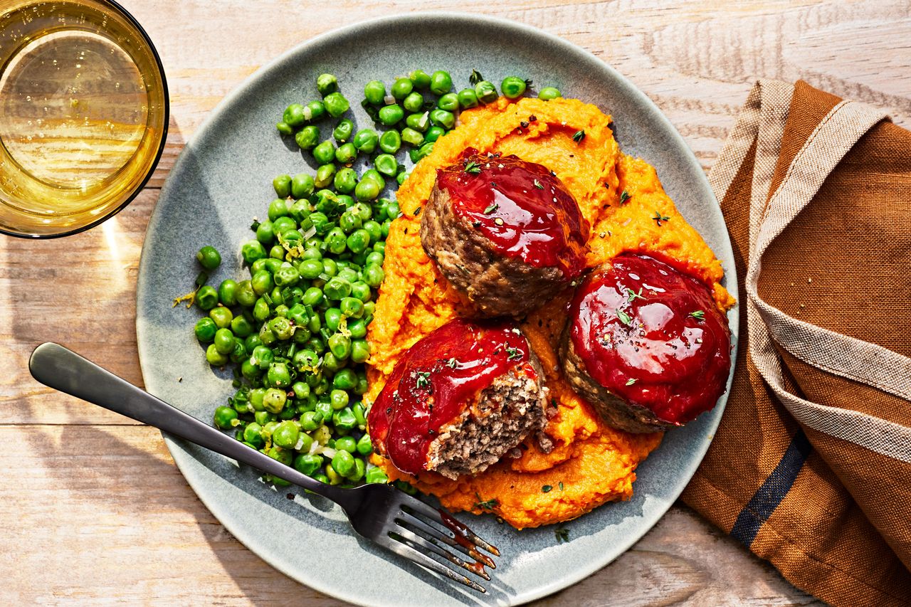 Southern Living Mini Meatloaves served over mashed sweet potatoes and buttery peas.