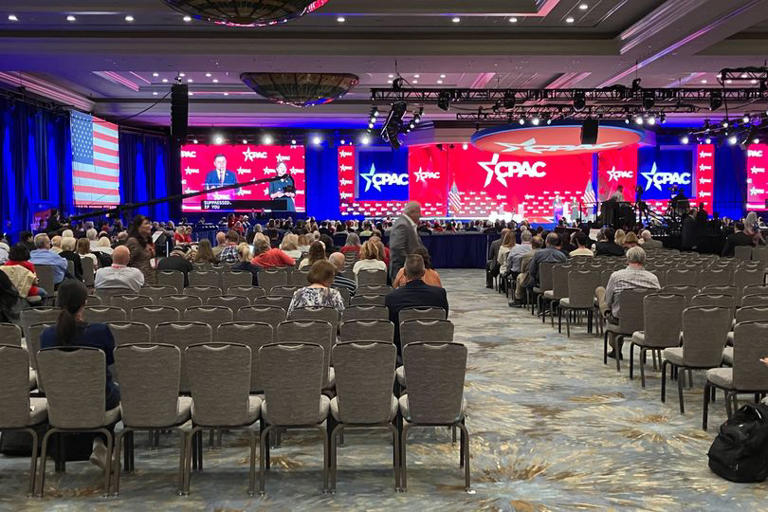 Wild moment CPAC audience member falls asleep as hundreds of seats left ...