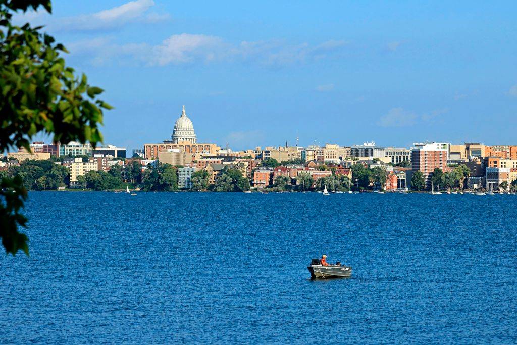 <p>Madison, Wisconsin sits on an isthmus, which means it's completely surrounded by water. No matter where someone is in the city they will almost always have a clear view of the gorgeous blue water. The ancient landscape in Madison was actually formed by glaciers many years ago.</p> <p>Travel experts urge visitors to come in the warmer seasons because the winters are usually cold and harsh. During those spring and summer months, people can go swimming at the lakes, take a stroll through the Olbrich Botanical Gardens, hit the trail at Cherokee Marsh, or gander at the "prairie-style" architecture.</p>