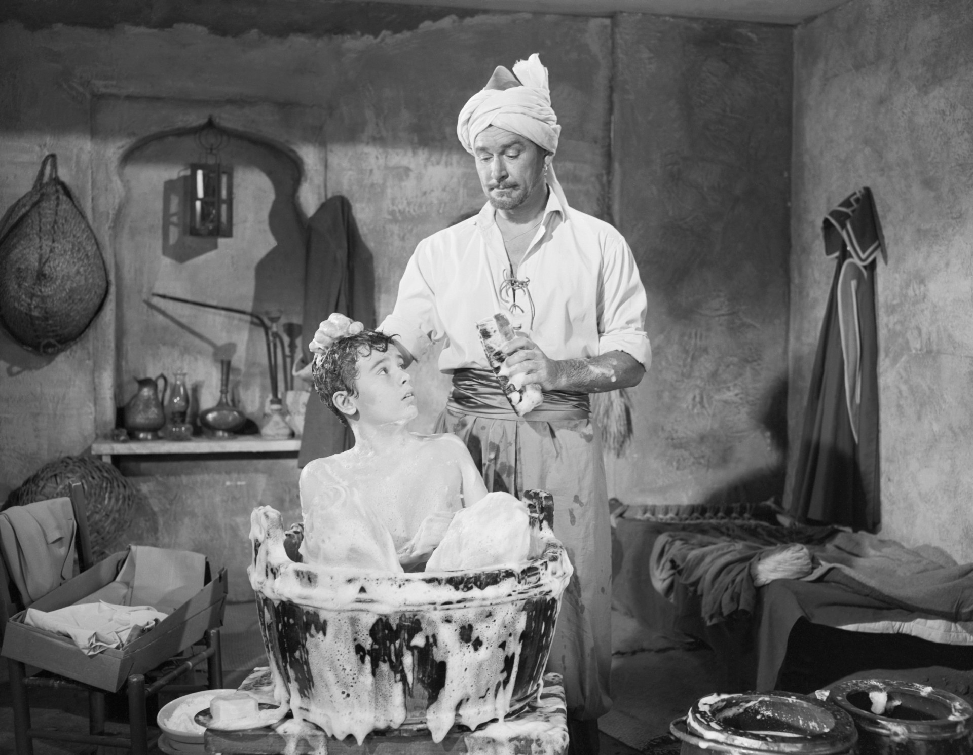 <p>Mahbub Ali (Errol Flynn) gives Kim (Dean Stockwell) a bubble bath in a scene from the 1950 adventure film 'Kim.' The movie was partly shot on location in India.</p><p>You may also like:<a href="https://www.starsinsider.com/n/391353?utm_source=msn.com&utm_medium=display&utm_campaign=referral_description&utm_content=546036en-en"> Madonna: the life and career of the 'Material Girl'</a></p>