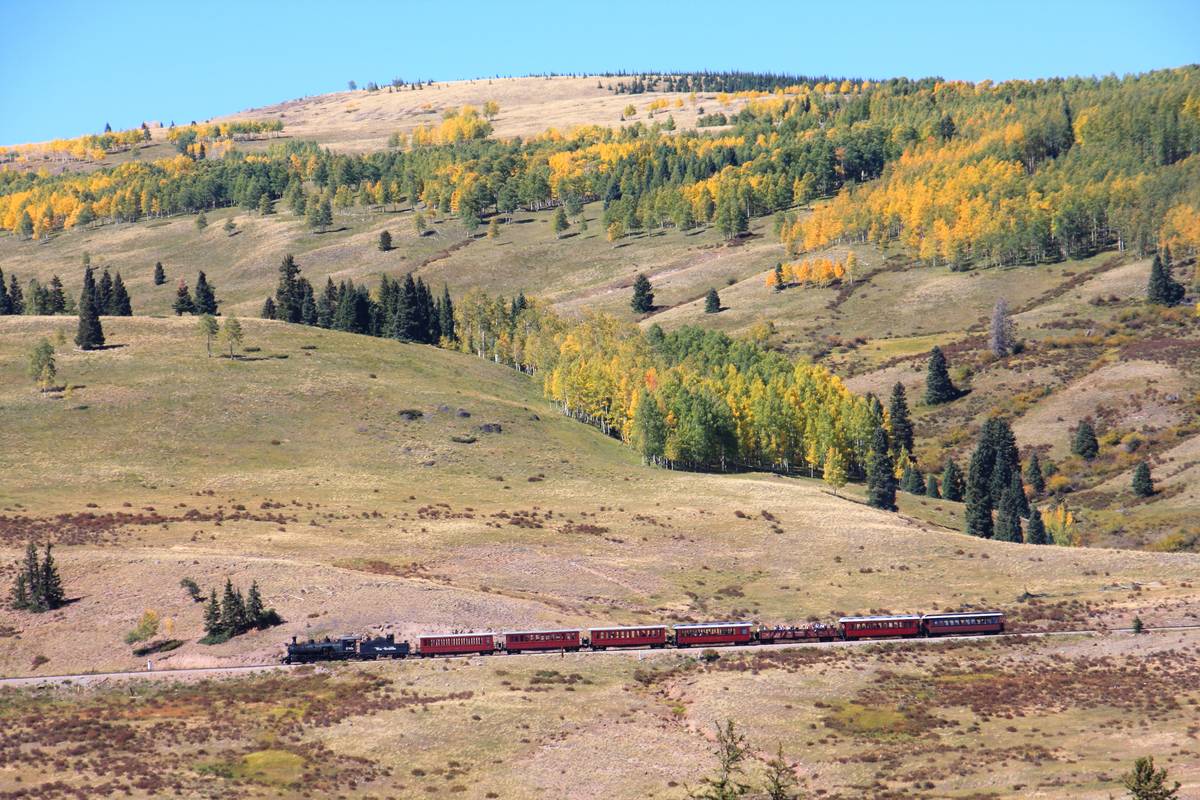<p>If you want to explore Colorado through the eyes of 19th-century gold and silver miners, hop on the <i>Cumbres & Toltec Scenic Railroad</i>. The locomotive zigzags through 64 miles of forests, the San Juan mountains, and the border of New Mexico. At its highest point, the train climbs 10,015 feet up a mountain! (Don't worry; it's only a 4% rise.)</p> <p>If you ride in the deluxe parlor car, you'll see that the coach glimmers with Victorian design and a golden shimmer. Keep your eyes out, and you may spot some elk or bears among the aspen trees.</p>