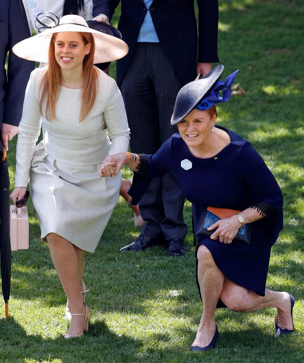 <p>Princess Beatrice holds the hand of her mother, Sarah, Duchess of York, as the two curtsy together in front of Queen Elizabeth's passing carriage.</p>