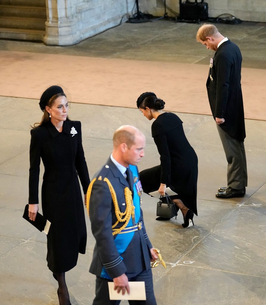 <p>Alongside Harry, Meghan dips into a low curtsy as she pays her respects to the coffin of Queen Elizabeth, which lies in state in Westminster Hall.</p>