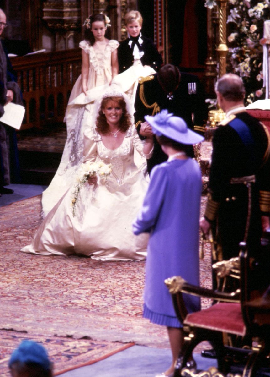 <p>Sarah, Duchess of York, curtsies to her mother-in-law during her wedding to Prince Andrew.</p>