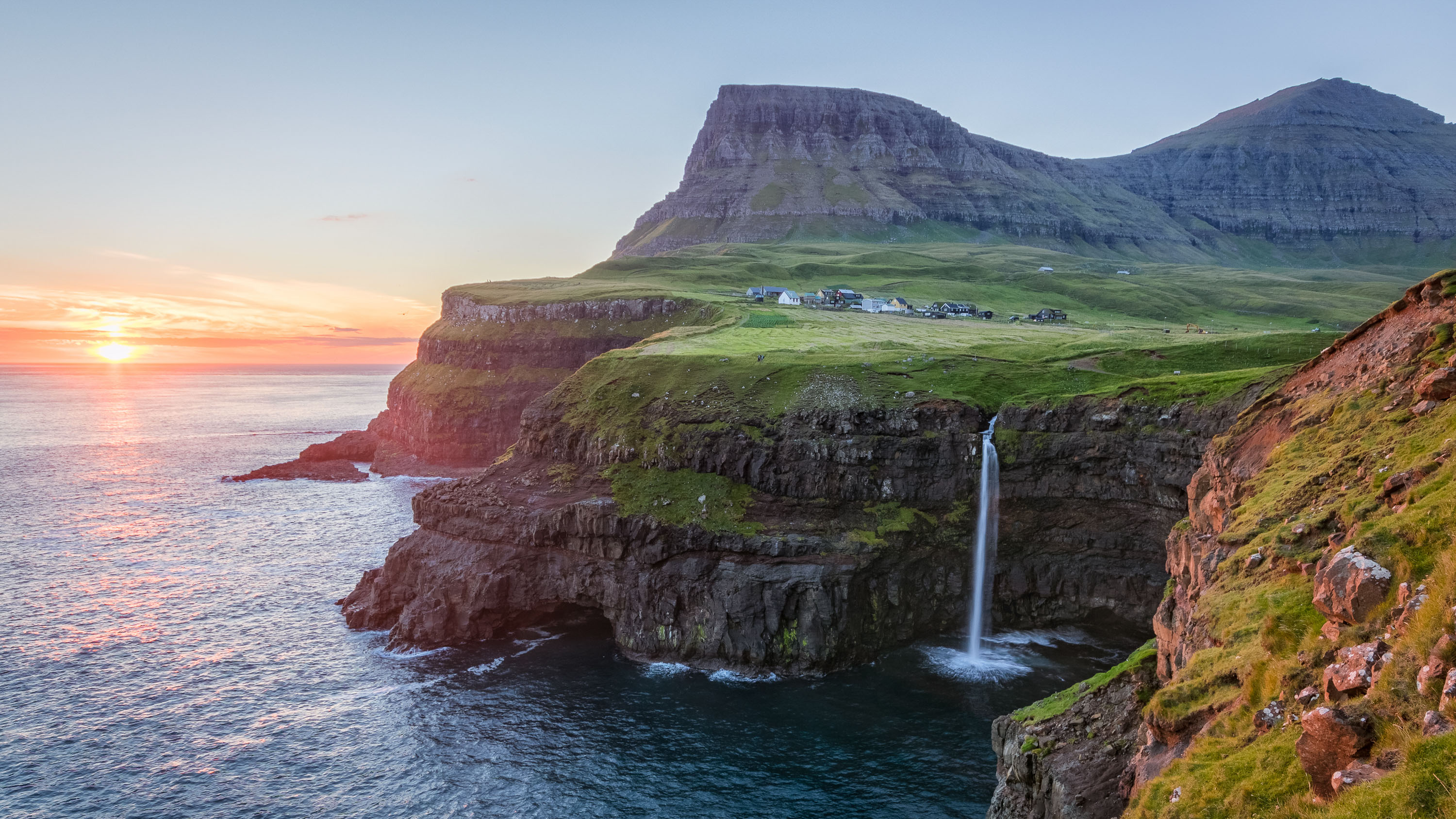 <p><strong>Estimated cost:</strong> $2,318</p> <p>You can see one of the world's most beautiful waterfalls at this secluded destination. Set atop a grassy seaside cliff with a tumbling waterfall pouring into the ocean is the tiny village of Gásadalur. Rugged mountains surround it on three sides, the sea on the fourth.</p> <p><strong><em>Related: <a href="https://www.gobankingrates.com/saving-money/travel/best-us-locations-to-travel-2k-budget/?utm_term=related_link_3&utm_campaign=1224529&utm_source=msn.com&utm_content=5&utm_medium=rss" rel="">5 Best US Locations To Travel To on a $2,000 Budget</a><br>More: <a href="https://www.gobankingrates.com/saving-money/travel/all-inclusive-resort-hacks-to-help-you-save-big/?utm_term=related_link_4&utm_campaign=1224529&utm_source=msn.com&utm_content=6&utm_medium=rss" rel="">10 All-Inclusive Resort Hacks That Can Help You Save Big</a></em></strong></p> <p>The village tucks away on the far western edge of the Faroe Islands, centered in the ocean between Iceland, Scotland and Norway. Transport yourself to simpler times of snug homes with grass-thatched roofs, visit its famous waterfall or hike the path that was once its primary connection to the outside world.</p> <p><strong>How to get there:</strong> Although the village was cut off from the outside world prior to 2004, a hole blasted through a mountain now allows automobile access directly from the airport, which makes it no longer the most isolated place in the world.</p>