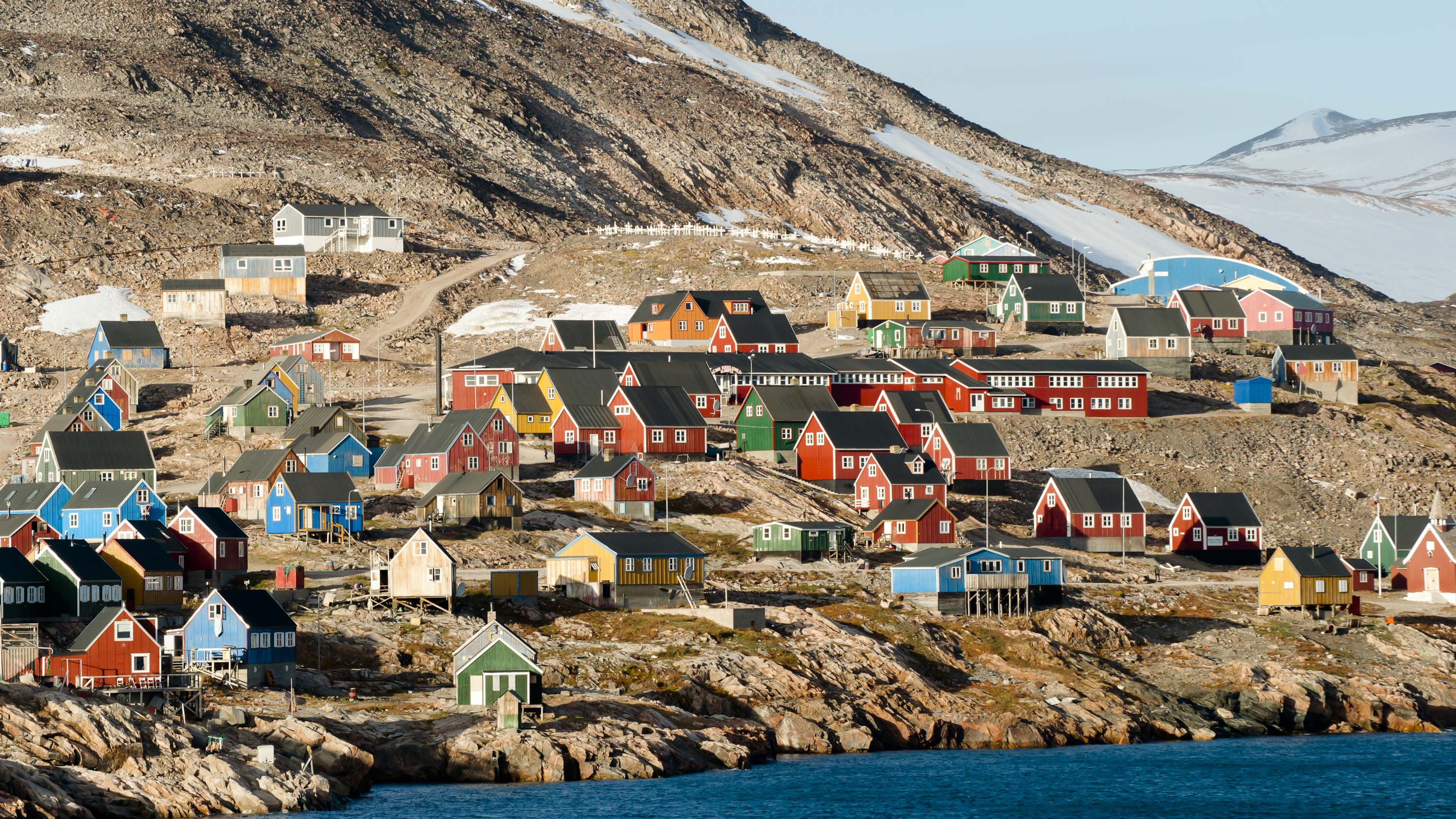 <p><strong>Estimated cost:</strong> $1,889</p> <p>Discover the most remote inhabited community in the Western Hemisphere when you visit the village of Ittoqqortoormiit. Just a few hundred people live in this colorful village, featuring houses painted bright shades of blue, red, gold and green, clinging to the foot of a snowy coastal mountain.</p> <p>Stay in the village and immerse yourself in local culture from visiting the local museum to seeing people go about their daily routines. You can also take a tour of other villages via dogsled or cross-country ski, or go sightseeing on snowmobile or foot.</p> <p><strong>How to get there:</strong> Fly to Reykjavik. The second flight to Akureyri lets you transfer to a small aircraft to access Nerlerit Inaat Airport, Greenland. Although this is the main airport, you won't be renting a car and going on your way. A 15-minute helicopter flight shuttles you from the airport into town.</p>
