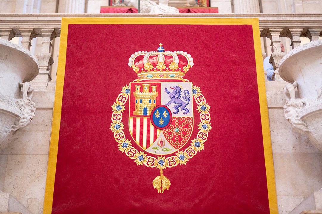 A flag with the Royal Coat of Arms greets all who enter Madrid’s palace, whether for regularly scheduled tours or official ceremonies. It is in front of the second sculpture of King Charles III, who is dressed in a Roman toga. He was the first monarch to occupy the new palace after it was built in the 18th century.