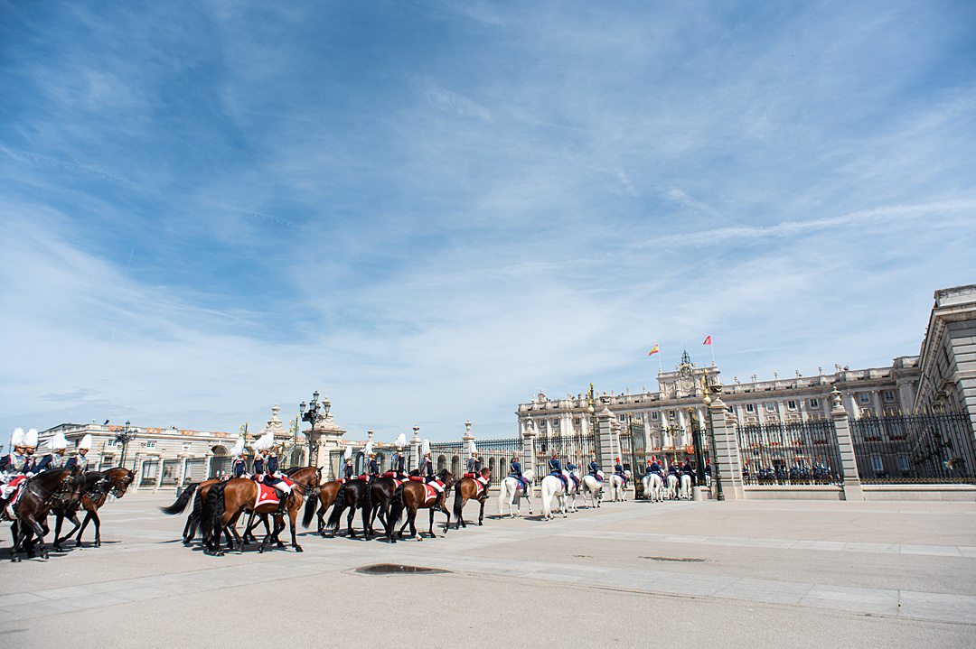 The Solemn Changing of the Guard takes place only once a month. However, many similarities exist between the ceremony pictured here and the Solemn Changing of the Guard.  More than 400 royal guards and approximately 70 horses are involved in the events. Both take place at the Royal Palace and, mainly, in Plaza de la Armería. While an official ceremony to receive a Head of State only takes place once in a while, the Solemn Changing of the Guard takes place every first Wednesday of the month. The usual Changing of the Guard, which is less opulent than the Solemn Changing of the Guard, takes place every Wednesday and Saturday at the Prince Gate of the Royal Palace, which faces Plaza de Oriente. This toned-down ceremonial Changing of the Guard involves four horses, four riders, and 12 footguards.