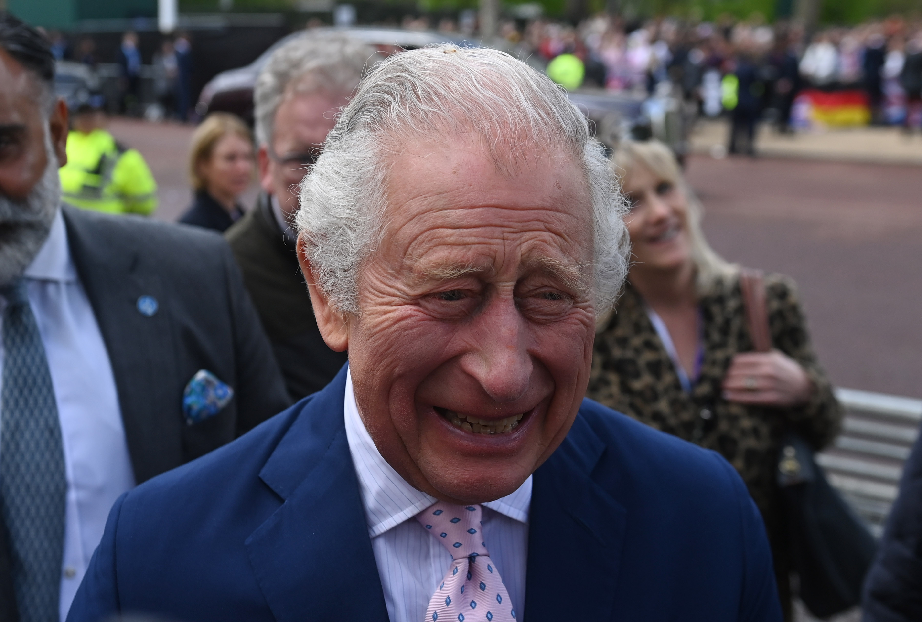 <p>King Charles III was all smiles as he greeted well-wishers along the Mall in London during a surprise walkabout on May 5, 2023 -- one day ahead of his coronation.</p>