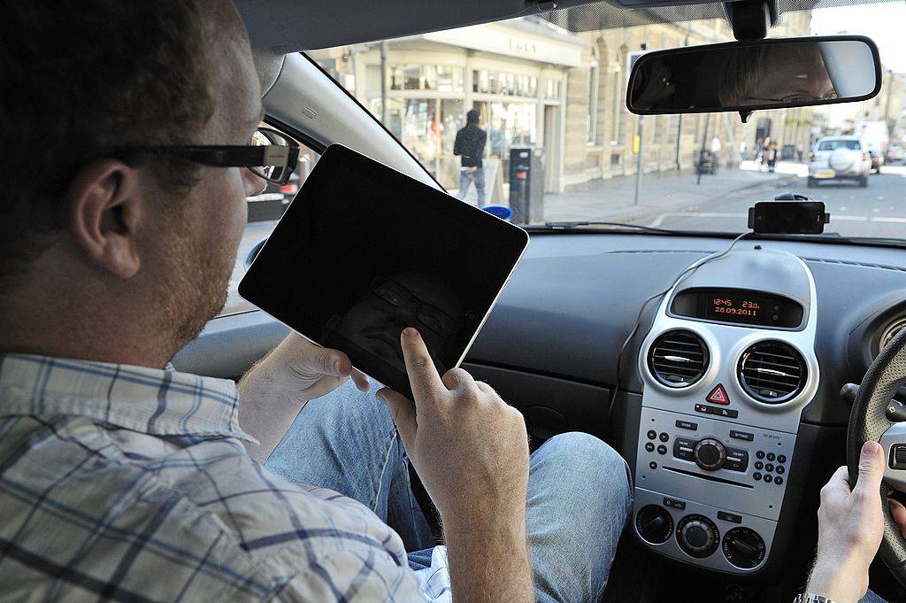 <p>Passengers would probably like something to do on a long road trip instead of just staring out the window. This is why people bring phones and tablets to watch their favorite movies and TV shows. Those who don't want to spend the whole trip holding up their iPad by hand should try this hack.</p> <p>If you are sitting up front and have a case that can fold, stick it through the sun visor. Those sitting in the back seats can place a hanging organizer from the backside of the front seats and slide their tablet or phone through the clear slots.</p>