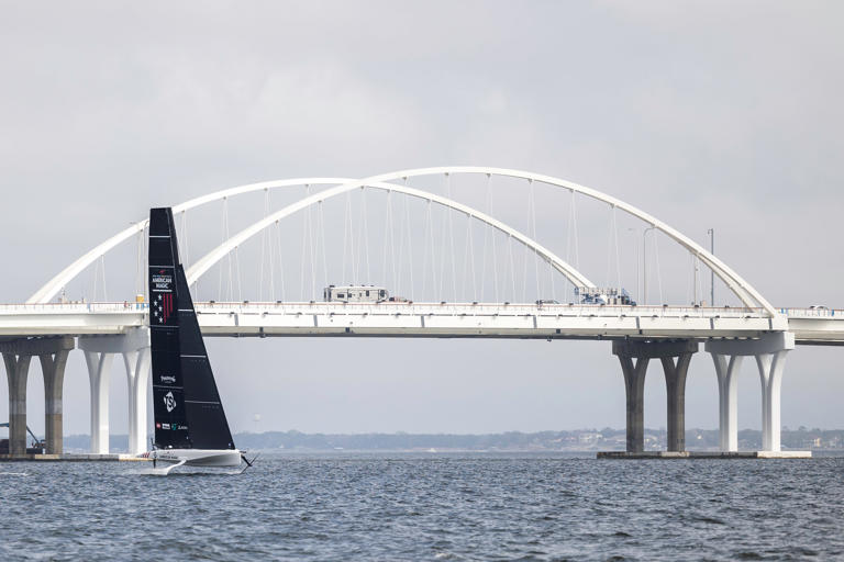 American Magic's AC40 "America" sails for the first time in Pensacola Bay near the Gen. Daniel "Chappie" James Bridge on March 9, 2023.