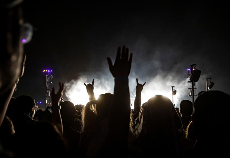 Festivalgoers sing along and cheer for Blink-182 as they perform their headlining set at the Coachella stage during the Coachella Valley Music and Arts Festival at the Empire Polo Club in Indio, Calif., Saturday, April 22, 2023.