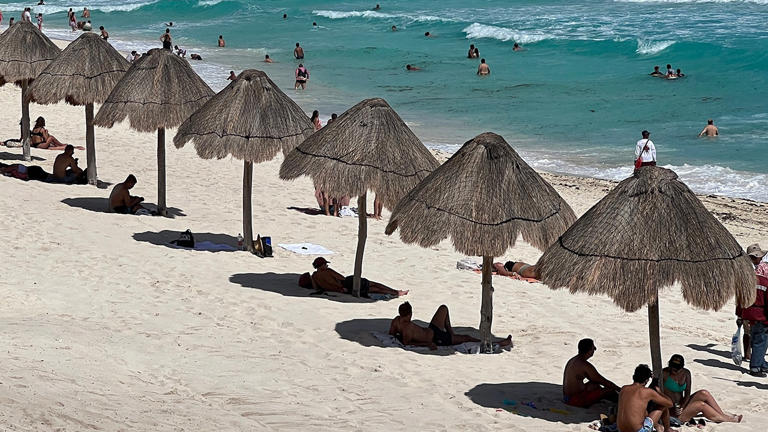 People enjoy a day at Playa Delfines beach (Dolphin Beach) at the Hotel Zone of Cancun, Quintana Roo State, Mexico, on November 8, 2022. DANIEL SLIM/AFP via Getty Images