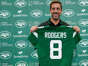 New York Jets' quarterback Aaron Rodgers poses with a jersey after a news conference at the team's training facility in Florham Park, New Jersey, Wednesday, April 26, 2023.