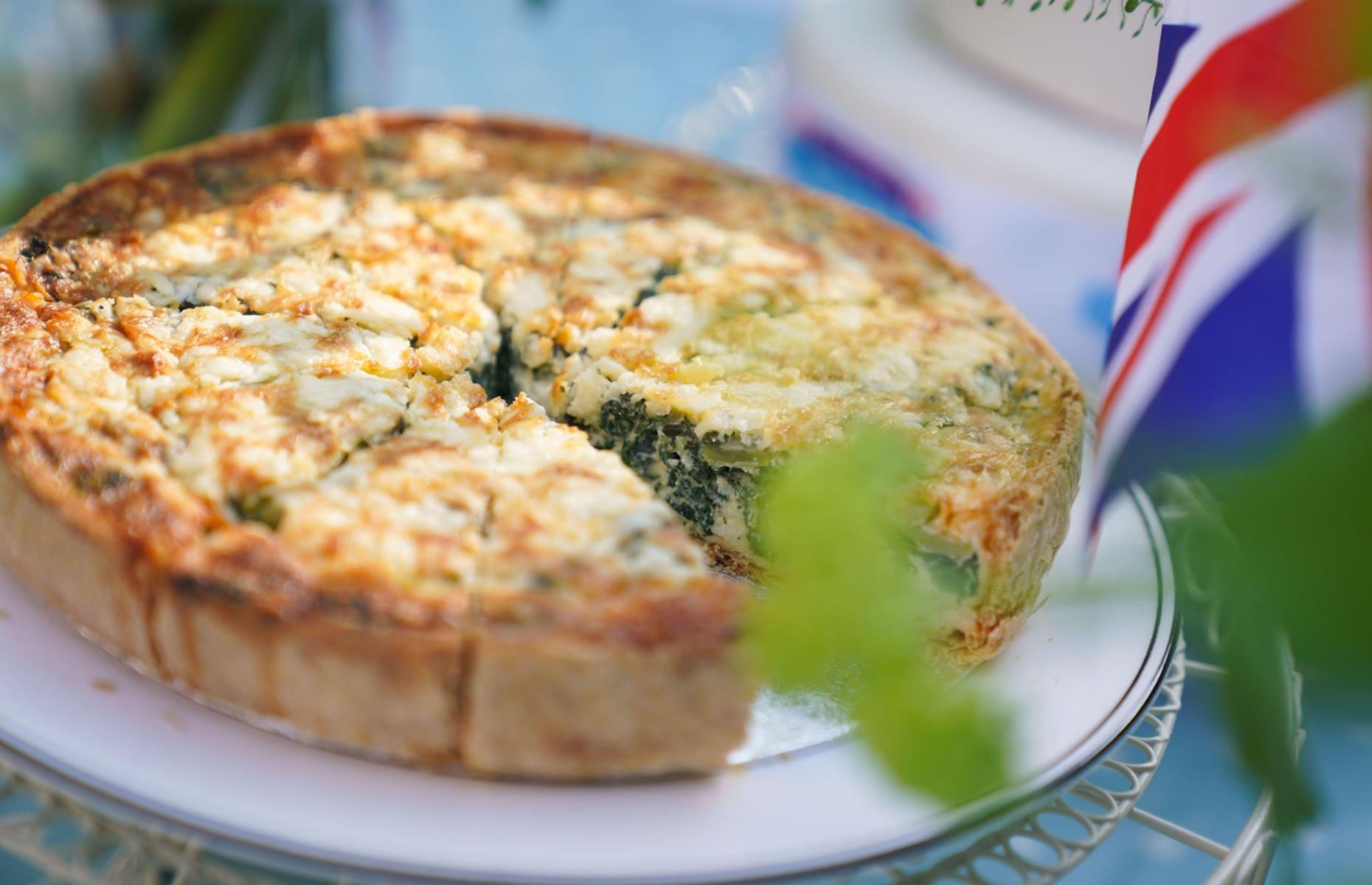 <p>The coronation quiche was personally chosen by King Charles and Queen Camilla to be the centrepiece dish of the 6 May celebrations. The quiche consists of spinach, broad beans, cheese and tarragon, with the <a href="https://www.royal.uk/the-coronation-quiche">recipe</a> available on the official Royal website. They suggest eating it hot or cold, with salad and new potatoes on the side.</p>