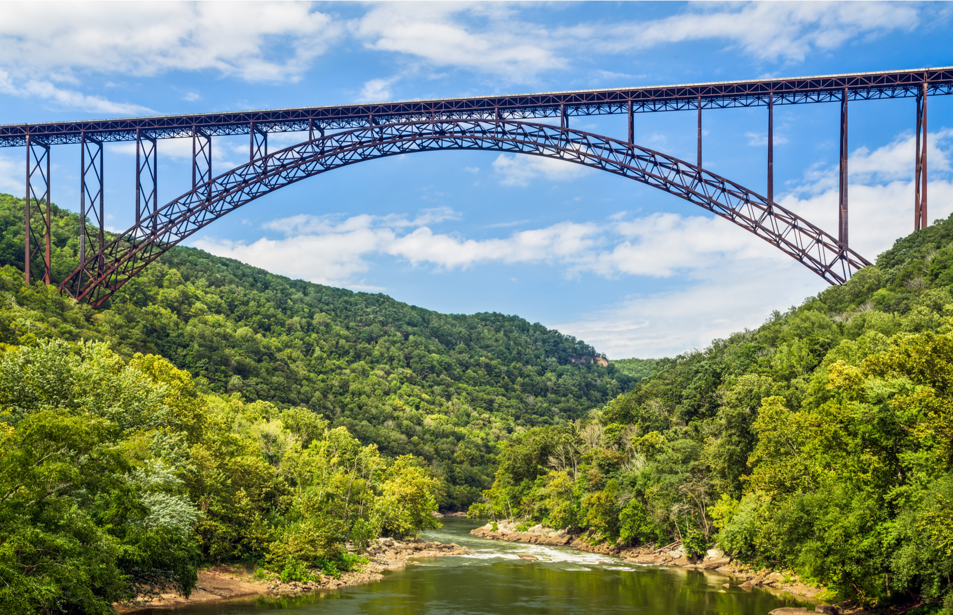 <p class="p1"><span>Though it’s since lost its title as the world’s longest single-span arch bridge, the New River Gorge Bridge in Fayetteville is no less a marvel of engineering, stretching 3,030 feet long and standing 876 feet high. For <a href="https://officialbridgeday.com/bridge-day-info" rel="noreferrer noopener"><span>one day every year</span></a></span><span>,</span><span> people are allowed to BASE jump off the bridge. </span></p>