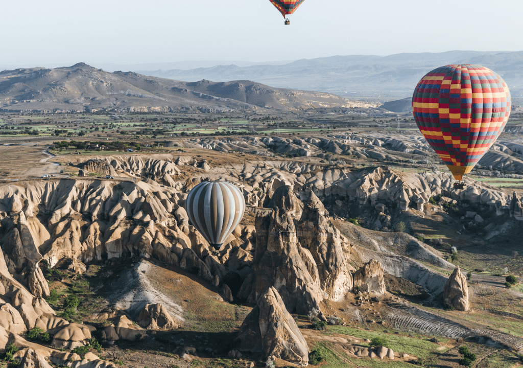 <p>Climbing into a hot air balloon and floating above the fairy chimneys in Cappadocia is a must-do on any Turkey itinerary. The hot air balloons operate every morning at sunrise and make for excellent pictures from above and on the ground.</p> <p>Be sure to book your Cappadocia hot air balloon ride in advance, for they often sell out during the high tourist season. Traveling during the off-season will offer you more opportunities to barter down the expensive experience, though the chance of weather-related hot air balloon cancellations increases.</p> <p>Aside from hot air ballooning in Cappadocia, there are also wonderful short and long hikes you can do in the area. Booking a stay at a hotel cave is a classic Cappadocia experience as well.</p>