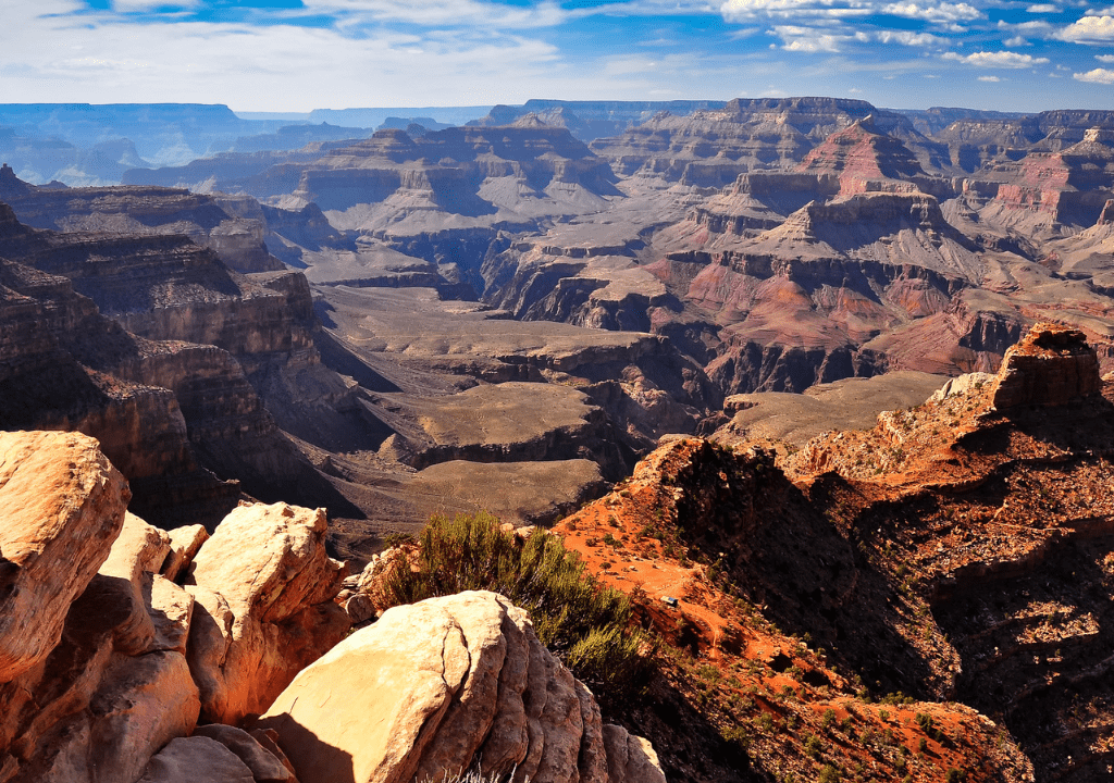<p>The Grand Canyon is another national park in the U.S. that’s every bit worth the visit if you didn’t have time to see it during your years in the office. It’s about one mile deep, 277 miles long, and 18 miles wide.</p> <p>Many people visit the Grand Canyon for hiking opportunities. But you don’t need to hike to appreciate stunning views over the canyon. You’ll encounter lookout areas with flat entrances near parking lots and restaurants that practically hang over the canyon’s ledge.</p> <p>Don’t miss the sunrises and sunsets, which make for extra colorful photo opportunities.</p> <p>Although locals offer the option to ride a donkey into the canyon, please think twice before arranging a ride. The animals often work in long, tiring conditions.</p>