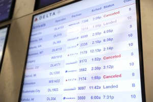 Screens showing several flight cancellations at the airport