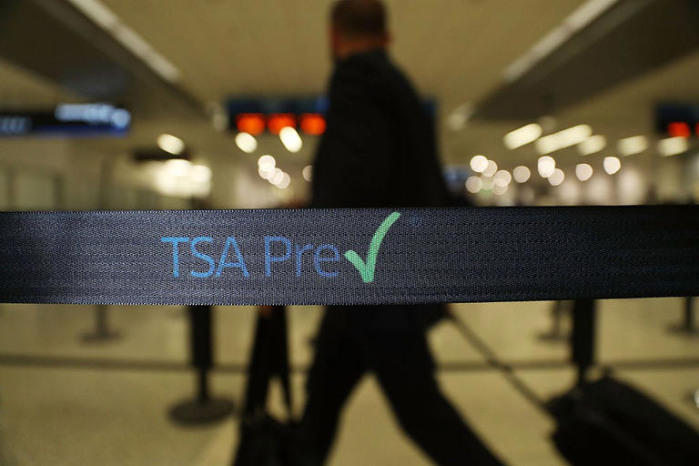 Travelers go through the TSA PreCheck security point at Miami International Airport in this file photo.