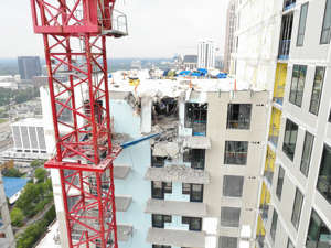 Damage is seen on the building where a portion of a crane collapsed on Monday.