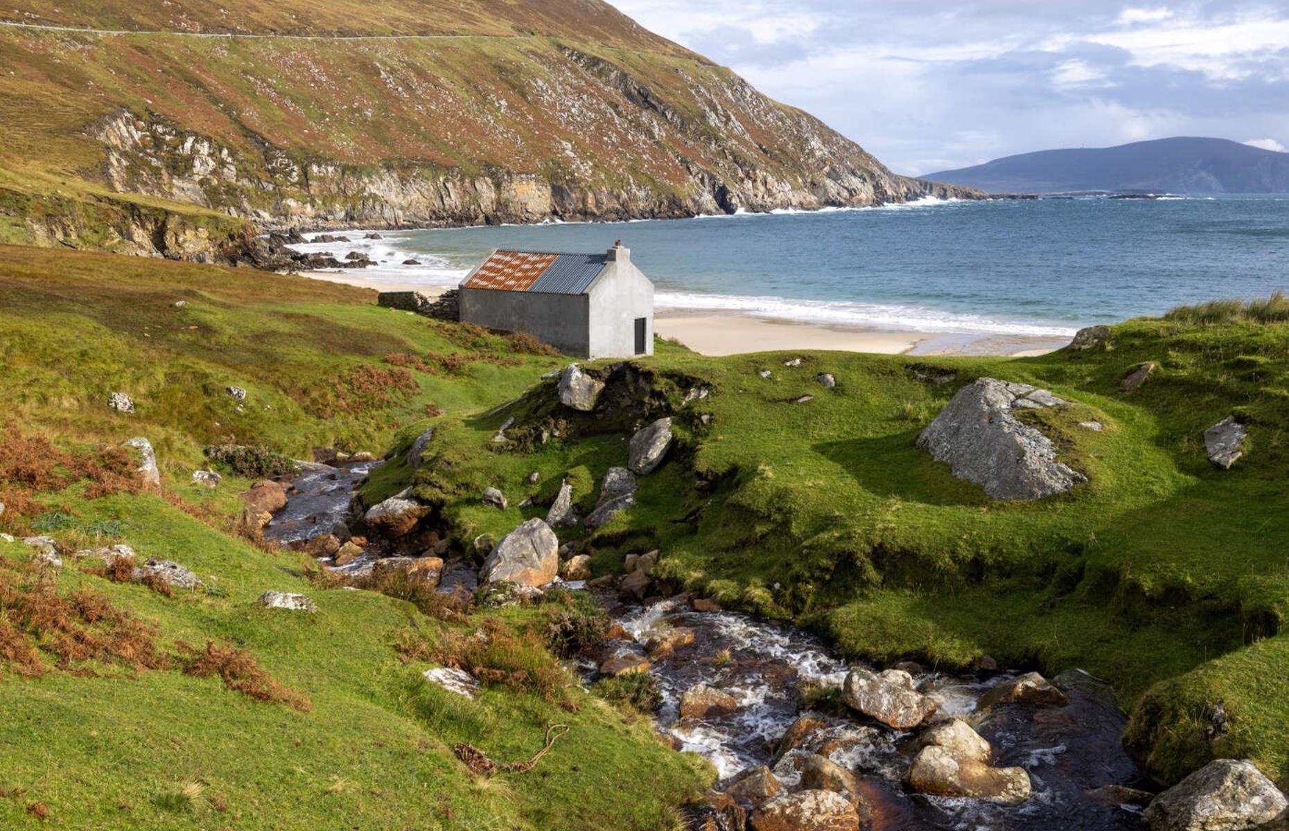 <p>It’s not hard to see why author Graham Greene visited Achill, the largest island off the west coast of Ireland, writing parts of <em>The Heart of the Matter</em> and <em>The Fallen Idol </em>in the village of Dooagh, near remote Keem Bay. This magical mix of peat bogs, mossy mountains and craggy coves offers a windswept coastal beauty that Ireland excels in. Step back in time to explore the deserted village of Slievemore, abandoned during the 19th-century famine when starving families relocated.</p>  <p><a href="https://www.loveexploring.com/galleries/101630/the-worlds-most-eerie-abandoned-towns-and-cities?page=1"><strong>Discover more of the world's most eerie abandoned towns and cities</strong></a></p>