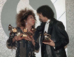 Tina Turner and Lionel Richie share a laugh as they celebrate their wins during the 1985 Grammy Awards in Los Angeles. ((Nick Ut / Associated Press))