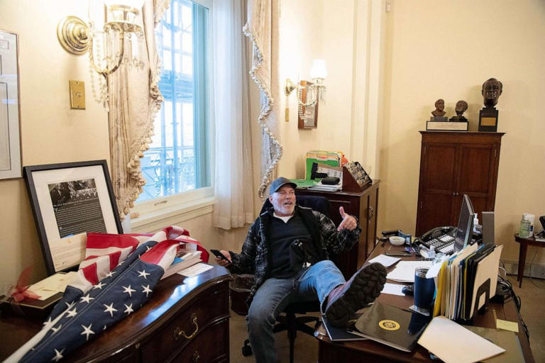 Richard Barnett, a supporter of President Donald Trump sits inside the office of Speaker of the House Nancy Pelosi as he protests inside the US Capitol in Washington, DC, Jan. 6, 2021.