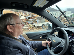 Montgomery mayor Greg Ingram drives through the city on his way to town hall, passing by the debris of a building being demolished – one of many that need to be torn down after sitting vacant for years since WVU Tech left town.