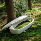 A Living Cocoon coffin and an EarthRise urn made by Dutch startup company Loop Biotech. The coffins are made from biodegradable mushroom and hemp fibers.