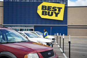 An employee delivers a purchase to a customer using curbside pickup at a Best Buy in Apple Valley, Minnesota.