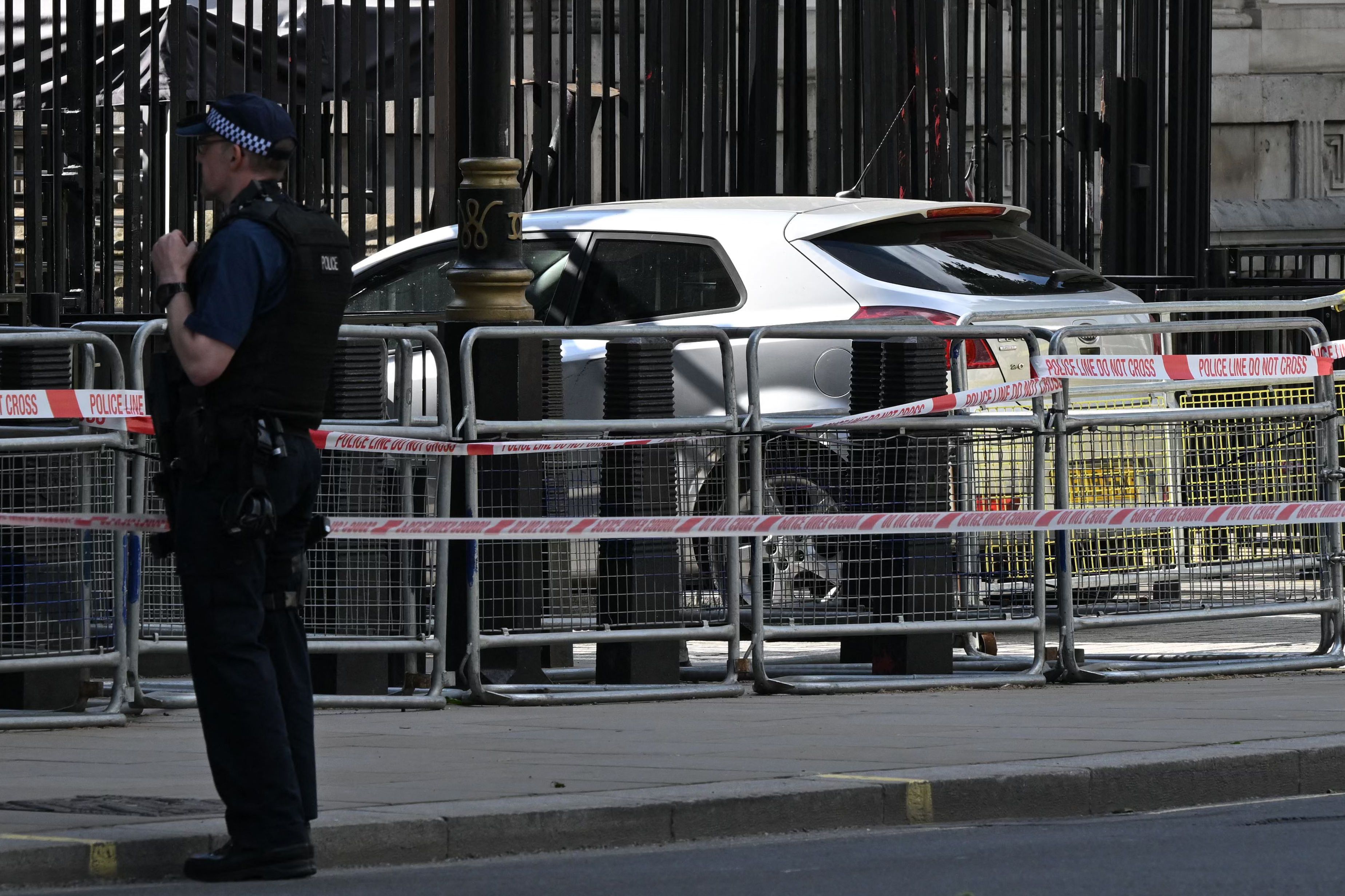 man arrested after car crashes into downing street gates