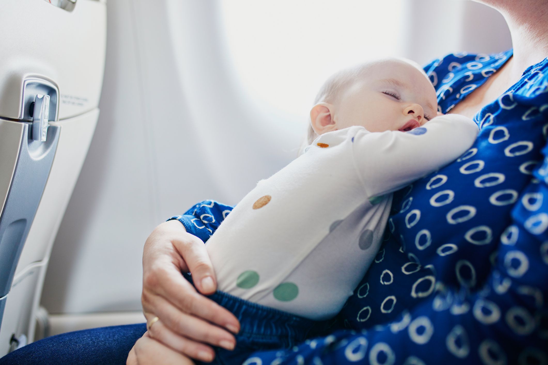 <h3>What to Bring</h3><p>The things you’ll need when traveling with a baby are not so different from what you need for a day in the park. Besides a stroller or carrier, you’ll want to make sure you’ve got enough amusements on hand to get your baby (and those around you) through the flight without much drama. I remember getting great new-parent tips from others about flying, including the advice to bring a small bag stuffed with distractions: board books, her Sophie the Giraffe teether, a light-up rattle. It was an excellent idea, even though she wound up happily playing with an empty plastic water bottle for much of our time in the air — anything that works!</p><p>If you’ve got a toddler who likes to snack, have plenty of their favorites with you (for yourself, too, as they’re not the only one who needs to be distracted from grumpiness). Other useful items to bring in your carry-on: plenty of diapers, wipes, a travel diaper pad to use in the cramped bathroom (not fun), formula, and a small cozy blanket.</p><h4>Dealing With Air Pressure Changes</h4><p>When flying with a baby, take-off and landing are likely to be the toughest parts, due to air-pressure changes in the cabin that can plug up their little ears. Start breastfeeding or bottle-feeding a few minutes before the actual take-off or landing. The sucking and swallowing actions will help their ears keep popping. Your little one will be blissfully unaware that they’re supposed to start screaming.</p>